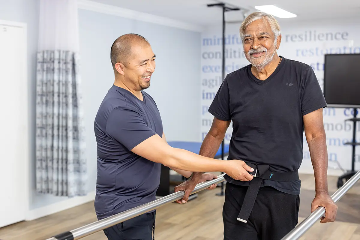 A physical therapist helping a man walk at Sunnyvale Post Acute